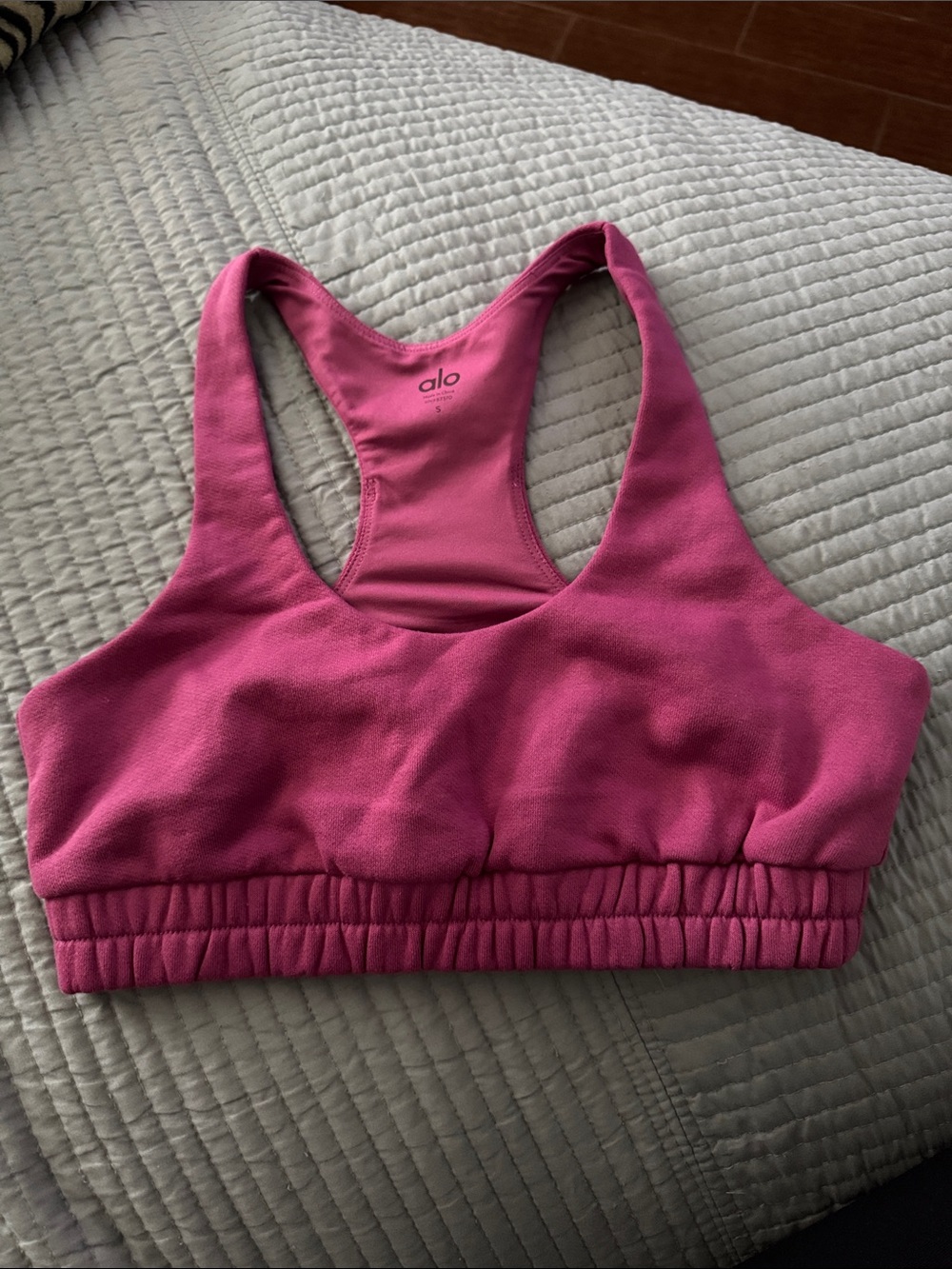 ALO Yoga tag with deep raspberry fabric